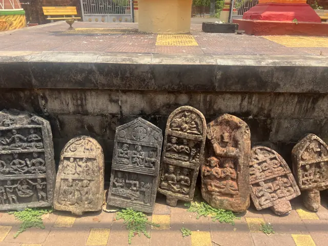 Old carved hero stones at a temple near Kankavli
