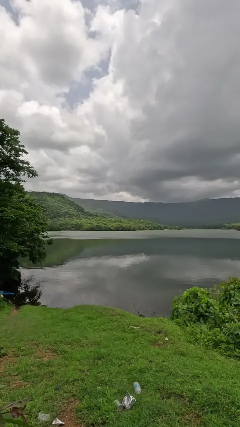 Still backwaters reflecting the hills near Kankavli