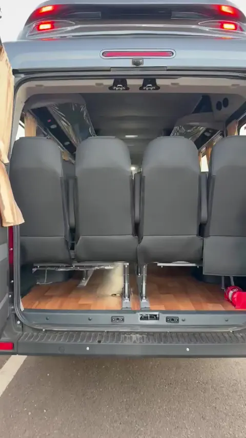 Rear doors of the Force Urbania open, showing the last row of seats