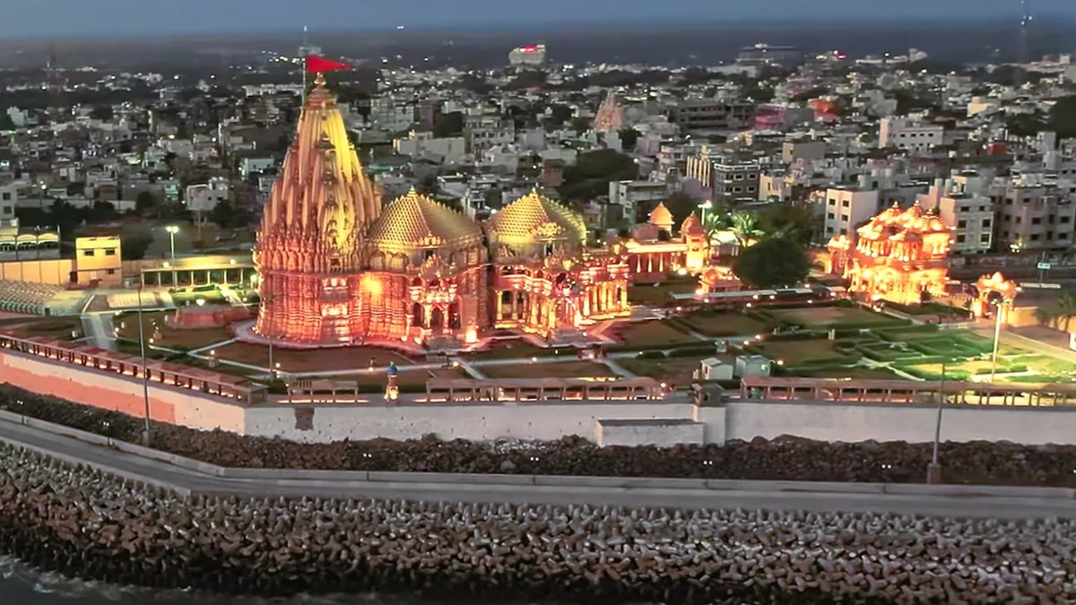 The Somnath temple lit at dusk above the Arabian Sea