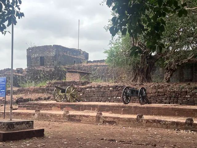 Old cannons and ramparts inside Vijaydurg Fort